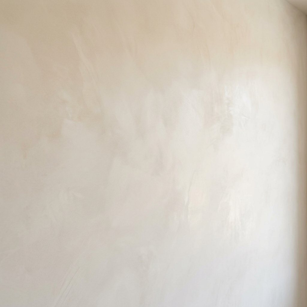 Smooth cream plaster wall texture used as a backdrop layer
